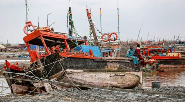 Fishermen check their damaged boat at a shore of the Arabian Sea, after Cyclone 'Tauktae' made landfall, near Una Town in Gir Somnath district, Tuesday, May 18, 2021. (PTI Photo)