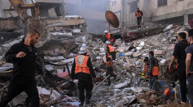 A building turned to rubble after an Israeli airstrike in Gaza City, Gaza Strip, May 16, 2021. The Israeli bombing in Gaza City killed at least 33 people, including 12 women and eight children, and wounded 50 others, according to Palestinian health authorities. They said the toll was likely to climb as rescuers picked through the rubble searching for victims and survivors. (Samar Abu Elouf/The New York Times)