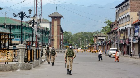 Security personnel patrol on a deserted street in Srinagar on Saturday. A curfew is in place in the Union Territory till May 17 owing to a surge in Covid-19 cases. (PTI)