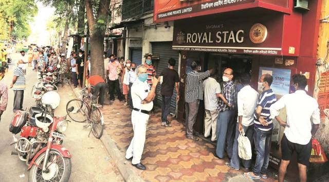 People queue up near a liquor store in Kolkata on Saturday. (Express Photo by Partha Paul)
