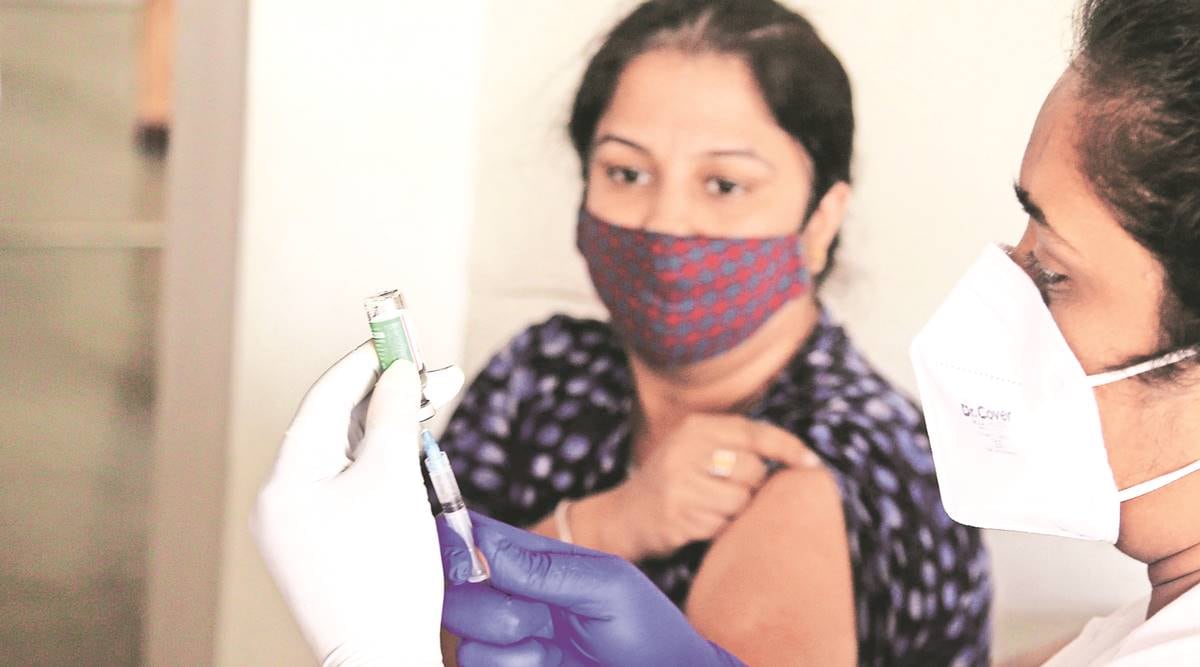 A medical worker prepares a dose of Covid vaccine at a camp, in Ludhiana Saturday. (Express Photo by Gurmeet Singh)