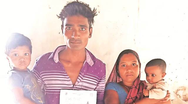 Shivkumar Ahirwar with his wife Krishna Bai and two children holds a letter stating that his registration to MP’s Mukhyamantri Jan Kalyan Sambal Yojna scheme has been cancelled.