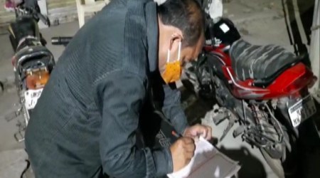 A violator pens Lord Ram's name down in a book. (Twitter/@ANI)