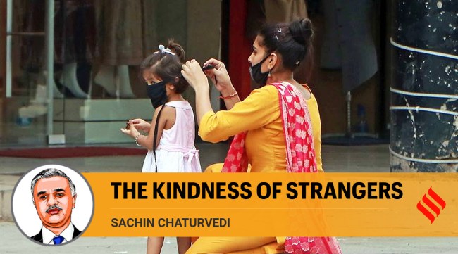 A mother helps her child to wear mask in Chandigarh (Express Photo by Kamleshwar Singh)