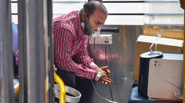 Bengaluru: A COVID-19 patient on oxygen support inside the 'Oxygen on Wheels', a bus that reaches out to patients in immediate need of oxygen, in Bengaluru (PTI)