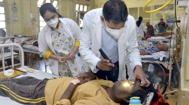 Doctors treat a patient infected with black fungus at NSCB Medical College and Hospital, in Jabalpur. (PTI Photo)