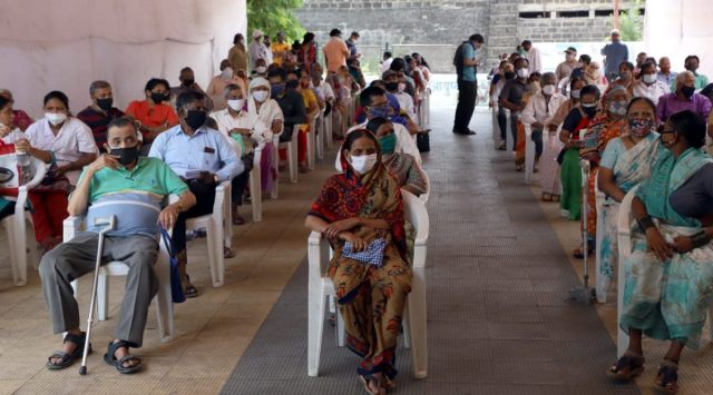 Senior citizens wait inside the vaccination center at Janata Vasahat Primary Health Centre near  Parvati Payatha  to take vaccine on Thursday morning. (Express Photo By Pavan Khengre)