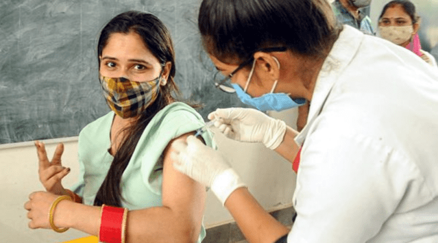 A beneficiary shows victory sign as she receives a Covid-19 vaccine dose, at a vaccination centre in Patiala, Wednesday, May 19, 2021. (PTI Photo)