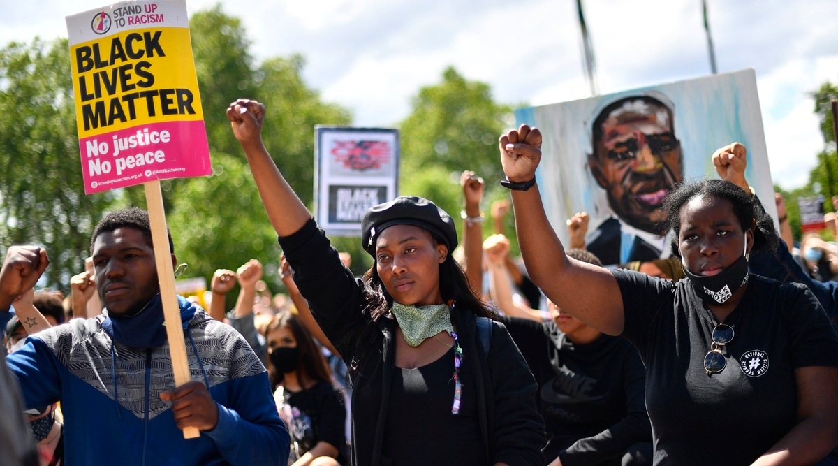 FILE - In this June 13, 2020 file photo, activist Sasha Johnson, centre, attends a protest at Hyde Park in London. An activist who has played a leading role in antiracism demonstrations in Britain is in critical condition after being shot in London, her political party says. The Taking the Initiative Party says Sasha Johnson was shot in the head on Sunday, May 23, 2021. (Victoria Jones/PA via AP, File)