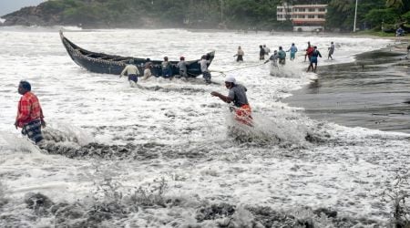 Thiruvananthapuram: People pull a boat ashore, which sailed away amid strong winds, after a red alert in view of a cylonic formation in the Arabian Sea, in Thiruvananthapuram, Friday, May 14, 2021. (PTI Photo)