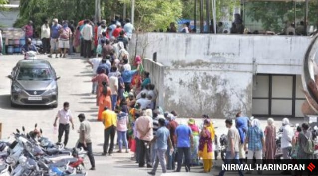 People queue up for Covid-19 vaccination at Tagore Hall in Ahmedabad Sunday.  (Express photo by Nirmal Harindran)
