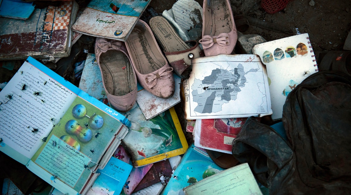 Items recovered outside Sayed Ul-Shuhada high school in Kabul, Afghanistan are laid out so families can identify and collect them after a bombing occurred that afternoon, on Saturday, May 8, 2021. Powerful explosions outside the high school in Afghanistan’s capital on Saturday killed at least 30 people and wounded dozens more, many of them teenage girls leaving class. (Kiana Hayeri/The New York Times)

