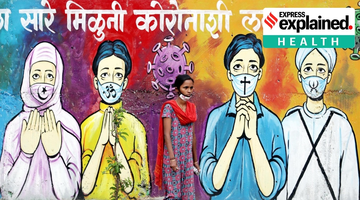 A woman walks past a Covid-awareness graffiti in Pune. (Express Photo: Arul Horizon)