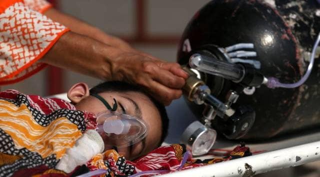 A child suffering low oxygen level, being admitted to Lohia Hospital in Lucknow. (Express Photo by Vishal Srivastav)