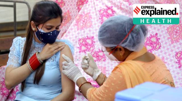 A woman is vaccinated against the novel coronavirus in New Delhi. (Express Photo: Amit Mehra)