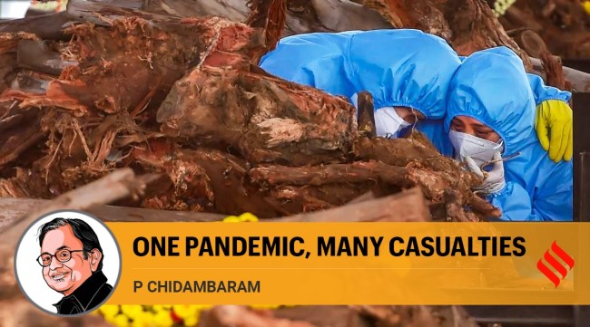 Family members perform the last rites of a COVID-19 victim at a crematorium set up on the outskirts of Bengaluru. (PTI)