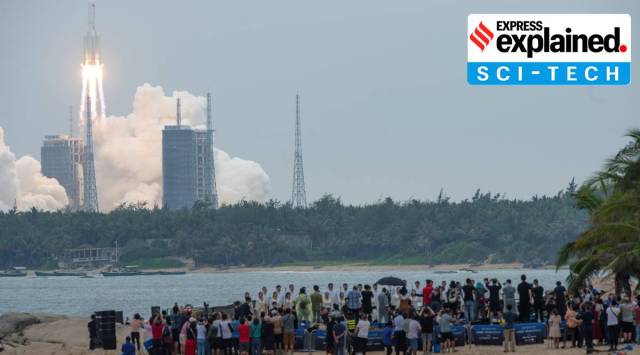 People watch from a beach as the Long March-5B Y2 rocket, carrying the core module of China's space station Tianhe, takes off from Wenchang Space Launch Center in Hainan province, China April 29, 2021. (Photo: China Daily via REUTERS)