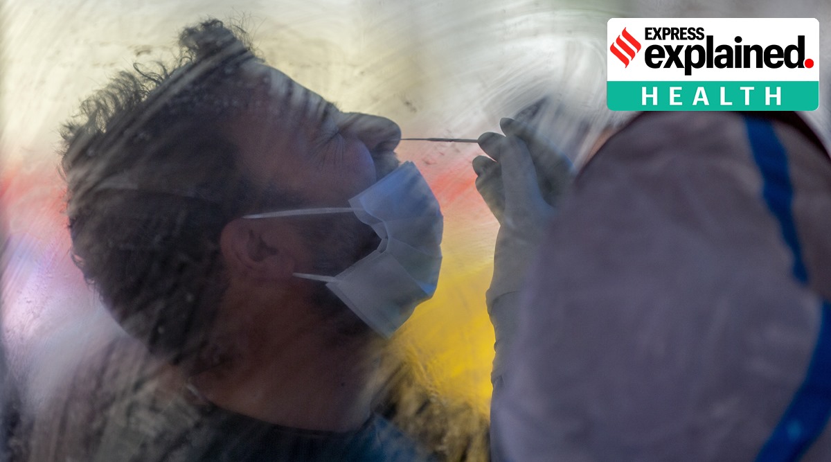 A health worker takes a nasal swab sample of a man to test for Covid-19 in Srinagar. (AP Photo/ Dar Yasin)