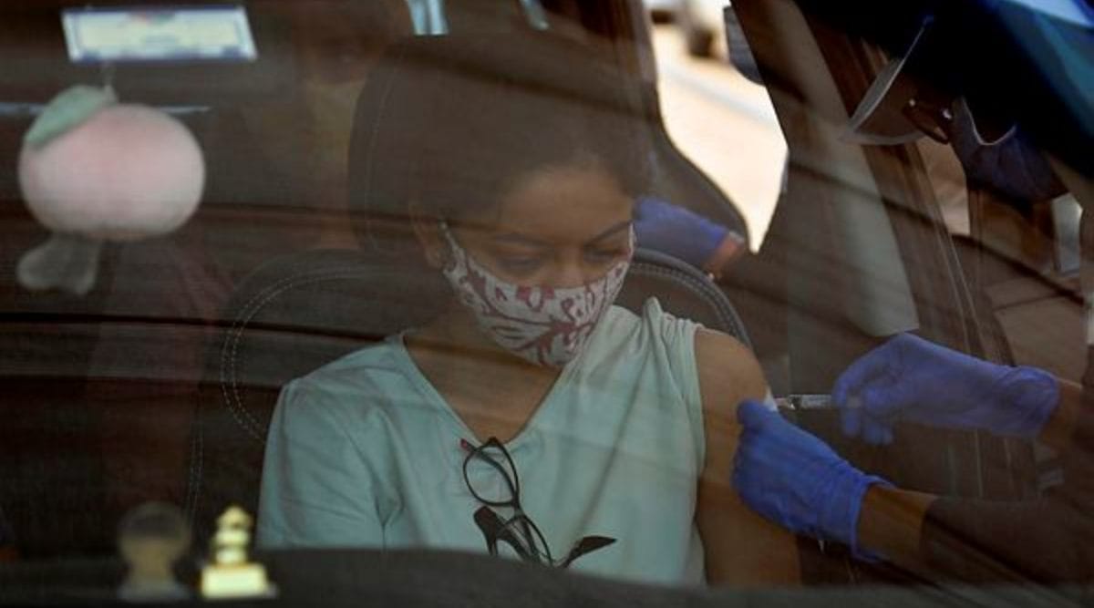 A woman receives a dose of Covishield, the Oxford-AstraZeneca vaccine for COVID-19 in her car at a drive-in vaccination facility in Ahmedabad, India, Friday, May 28, 2021. (AP Photo)