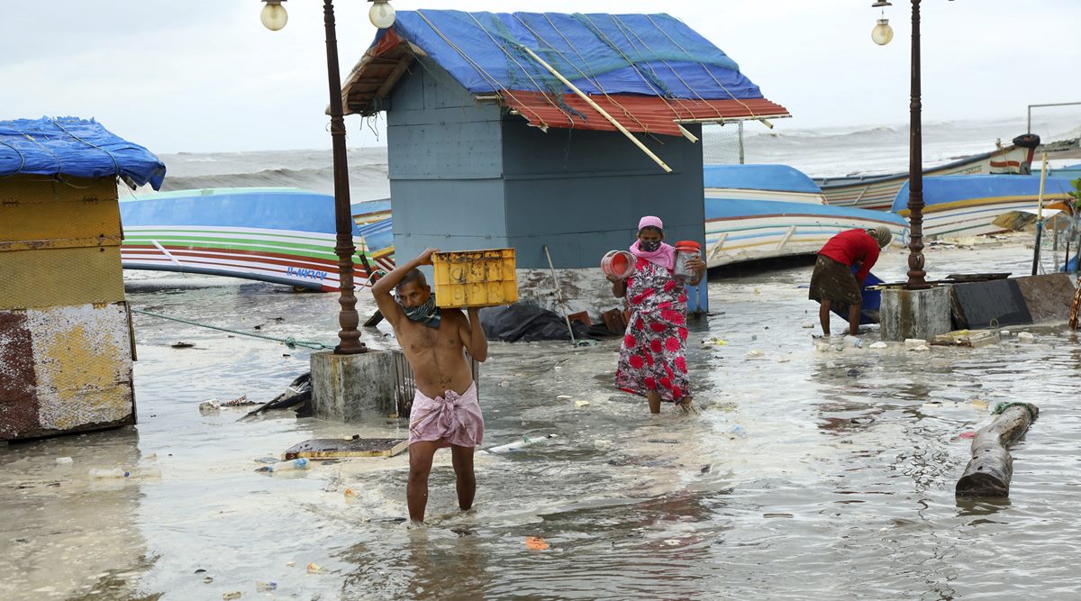 People carry belongings as they move away from the sea shore, after a red alert due to the formation of Cyclone Tauktae, at Baypore in Kozhikode, Friday, May 14, 2021. (PTI Photo)