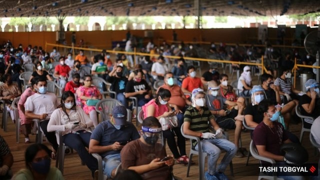 People wait inside a Covid-19 vaccination centre to get their jabs in New Delhi. (Express Photo by Tashi Tobgyal) 