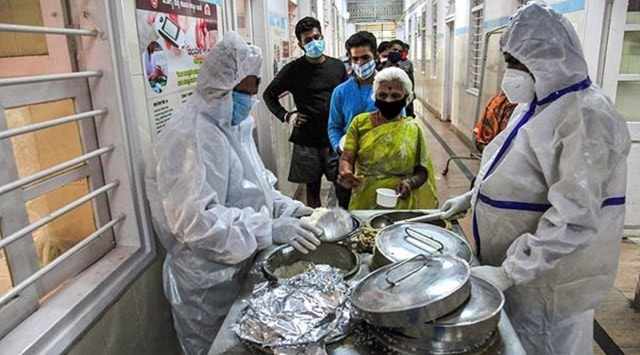 Health workers serve food to Covid patients in Bengaluru. (File photo/PTI)
