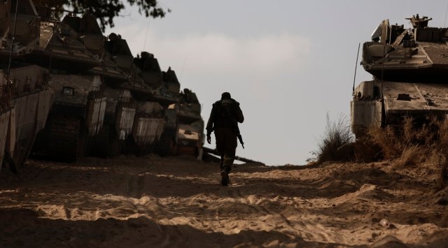 An Israeli soldier walks at a staging ground near the border with the Gaza Strip, in southern Israel, Thursday, May 20, 2021. (AP Photo/Maya Alleruzzo)