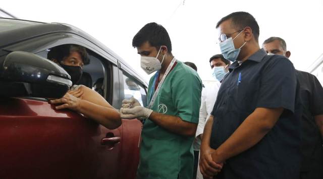 CM Arvind Kejriwal during the inauguration of Delhi’s  first drive-through Covid vaccination centre at Vegas Mall in Dwarka, Wednesday. (Express photo by Praveen Khanna)