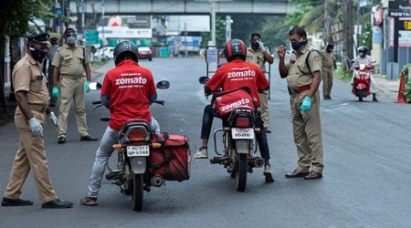 Policemen check the credentials of food delivery personnel during a lockdown imposed to curb the spread of coronavirus in  Kerala, which emerged as a blueprint for tackling the pandemic last year, began a lockdown on Saturday. (AP Photo)