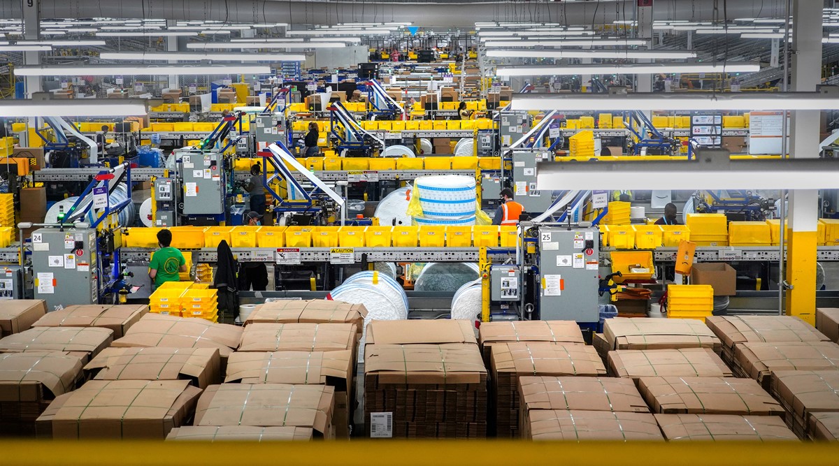 Workers in the packing area at Amazon's warehouse on Staten Island, called JFK8, on March 2, 2021. Each year, hundreds of thousands of Amazon workers churn through a vast mechanism that hires and monitors, disciplines and fires.  (The New York Times)