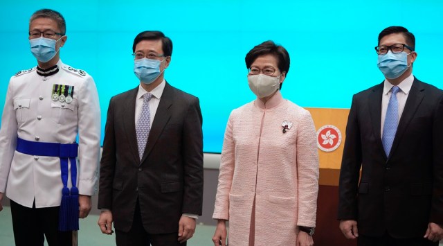 Hong Kong's Chief Executive Carrie Lam, second right, poses with Chief Secretary John Lee, second left, Secretary for Security Chris Tang, and Commissioner of Police Raymond Siu during a news conference in Hong Kong, Friday, June 25, 2021. China on Friday promoted Hong Kong's top security official to the territory's No. 2 spot as Beijing continues to clamp down on free speech and political opposition. (AP Photo)
