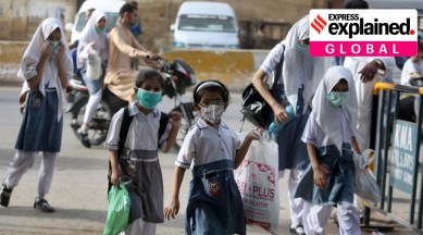 Student wearing face masks to help prevent the spread of the coronavirus arrive at a school in Karachi (AP)
