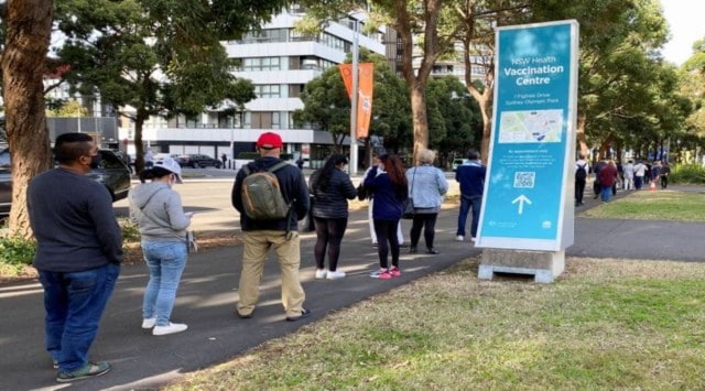 People wait in line outside a coronavirus disease vaccination centre at Sydney Olympic Park in Sydney, Australia, June 23, 2021.  (Reuters Photo: Loren Elliott)
