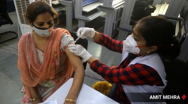 A health worker administers a dose of the Covid-19 vaccine in New Delhi. (Express Photo: Amit Mehra)