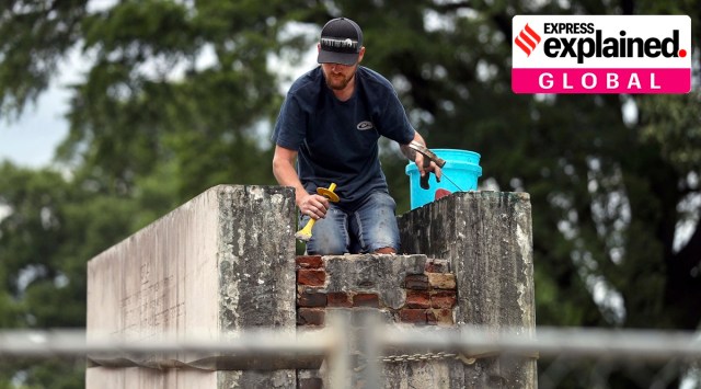 Construction crews hired by the family of Confederate Gen. Nathan Bedford Forrest work to dismantle his grave at Health Sciences Park on Tuesday, June 1, 2021, in Memphis, Tenn. (Patrick Lantrip/Daily Memphian via AP)