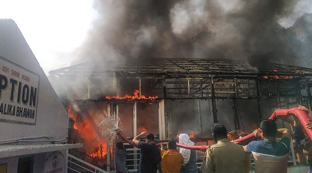 Firefighters try to douse a fire at a building situated near Mata Vaishno Devi shrine, at Trikuta hills in Katra, Tuesday, June 8, 2021. (PTI)
