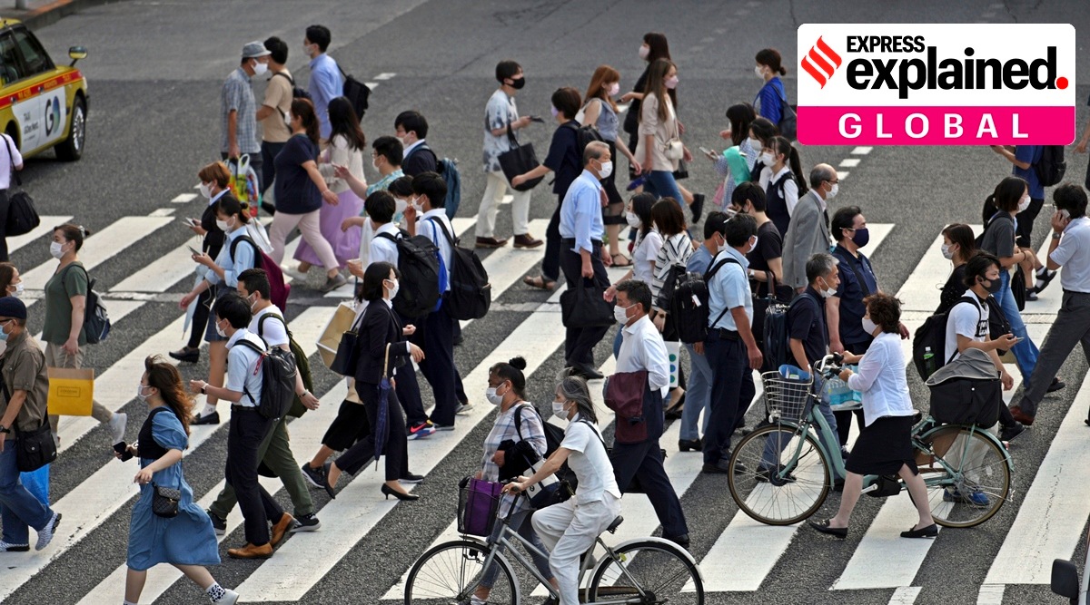 People wearing protective masks to help curb the spread of the coronavirus walk along a pedestrian crossing Friday, June 25, 2021, in Tokyo. The Japanese capital confirmed more than 560 new coronavirus cases on Friday. (AP Photo/Eugene Hoshiko)