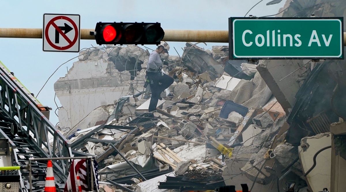 A rescue worker walks among the rubble where a wing of a 12-story beachfront condo building collapsed, Thursday, June 24, 2021, in the Surfside area of Miami. (AP)