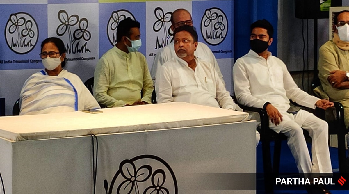 BJP leader Mukul Roy with West Bengal Chief Minister Mamata Banerjee, TMC national general secretary Abhishek Banerjee and others in Kolkata on Friday. (Express photo by Partha Paul)