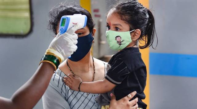A healthcare worker takes the temperature of a child amid the Covid-19 pandemic. (File photo)