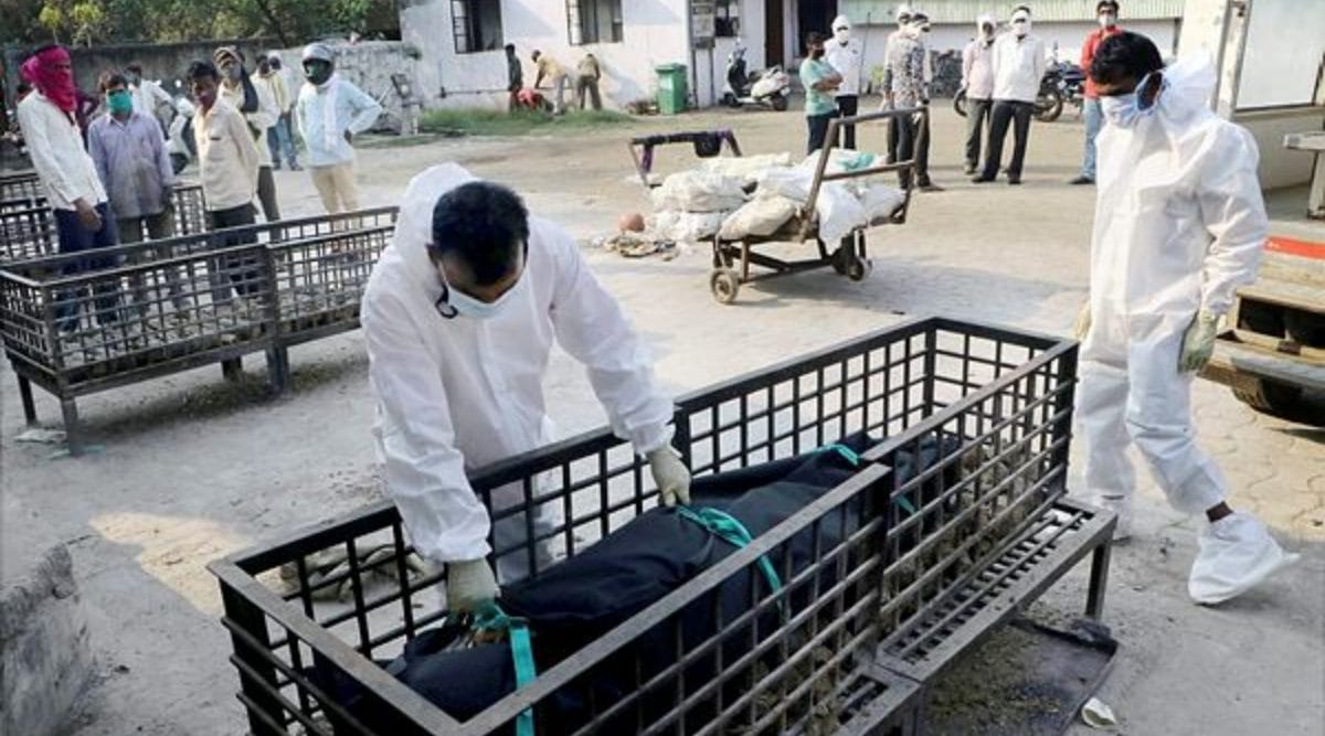 Health workers place the body of a COVID-19 victim on a pyre for cremation at Mokshadham Ghat in Nagpur, Friday, May 28, 2021. (PTI Photo)