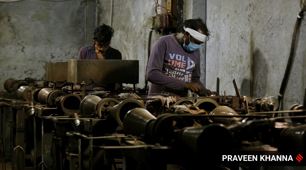 Labourers working in a factory in New Delhi. (Express Photo/Praveen Khanna)