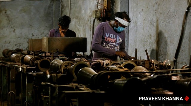Labourers working in a factory in New Delhi. (Express Photo/Praveen Khanna)
