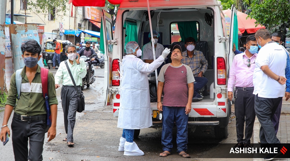 PMC staff collect swab samples of super spreaders like shop keepers, fastfood joint vendors, street vegetable sellers on JM road. (Express Photo by Ashish Kale)