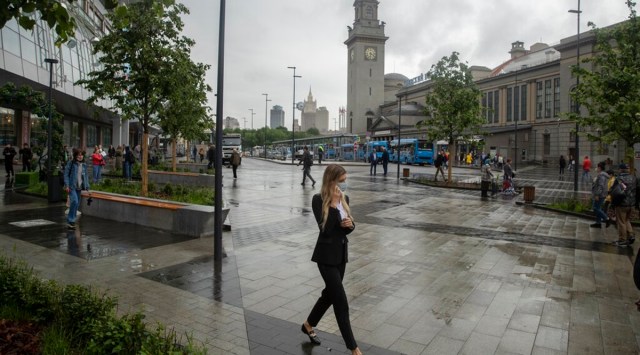 A woman wearing a face walks in a street in Moscow, Russia. (AP Photo)
