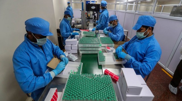 Employees pack boxes containing vials of Covishield, a version of the AstraZeneca vaccine at the Serum Institute of India in Pune, India. (AP Photo)
