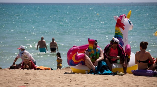Tourists sunbathe on the beach at the Spanish Balearic Island of Mallorca, Spain. (Photo: AP)