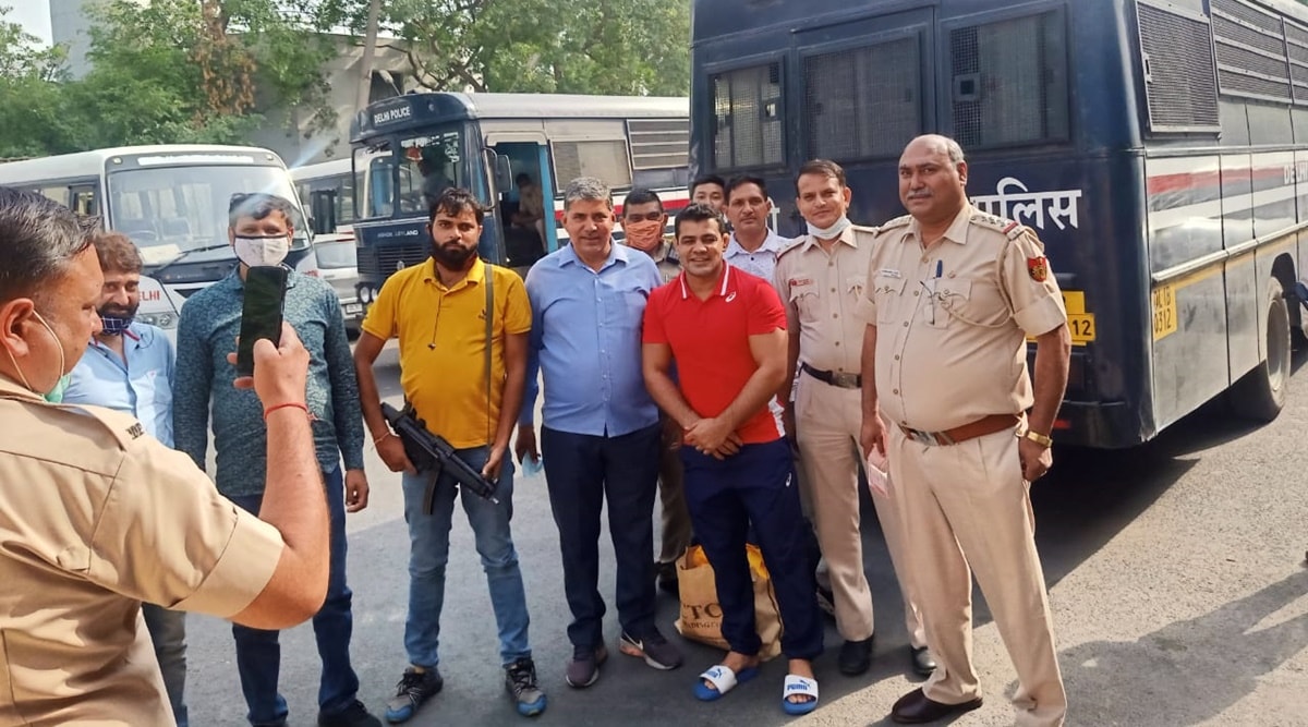 Delhi Police personnel click pictures with two-time Olympic medallist Sushil Kumar outside Mandoli jail on Friday. (Express Photo)