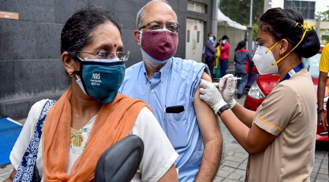 A health worker administers a dose of the COVID-19 vaccine to a person at a drive-in vaccination centre, at MGM Hospital, in Chennai. (Photo: PTI)