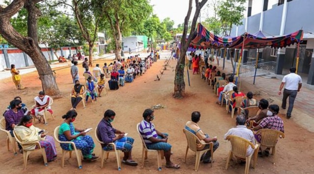 People wait to recieve the token for Covid-19 vaccine at the Ramanathapuram health care centre in Coimbatore, Wednesday, June 23, 2021. (PTI Photo)